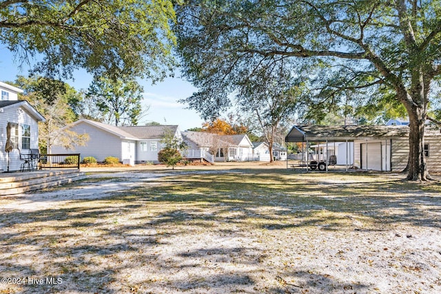 view of yard featuring a deck and a carport