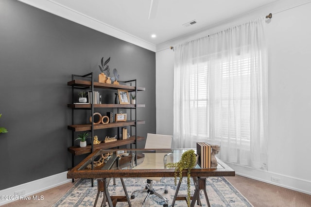 office area with carpet floors, crown molding, baseboards, and visible vents