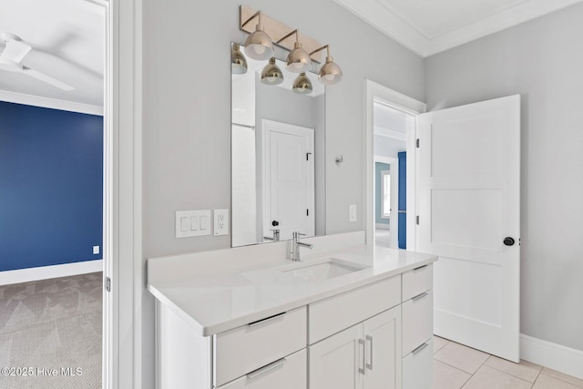 bathroom with baseboards, ceiling fan, vanity, and crown molding