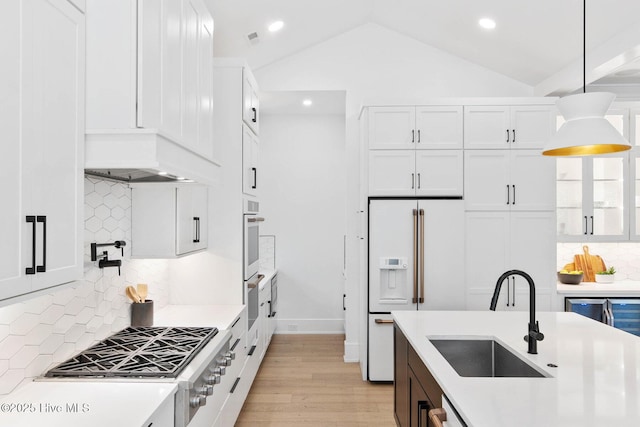 kitchen with white appliances, light countertops, recessed lighting, and a sink