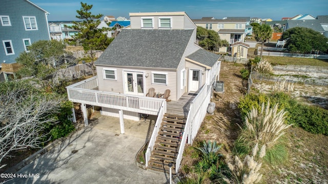 204 Oyster Ln, North Topsail Beach, NC 28460 - rear view of property featuring a shingled roof, french doors, driveway, stairway, and central air condition unit