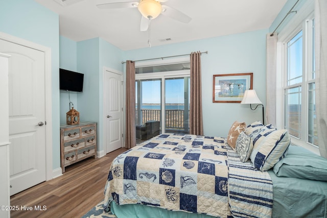 bedroom with wood finished floors, visible vents, a ceiling fan, baseboards, and access to outside