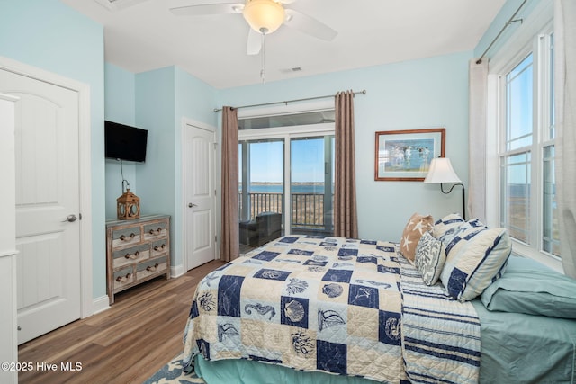 bedroom with access to exterior, wood finished floors, multiple windows, and visible vents
