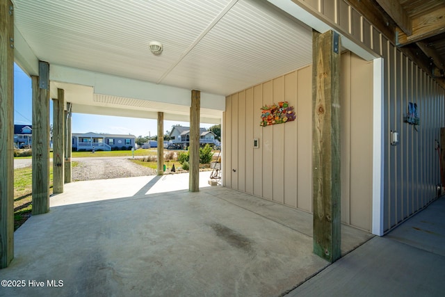 view of patio with a residential view, driveway, and an attached carport