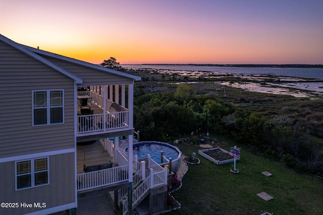 aerial view at dusk with a water view