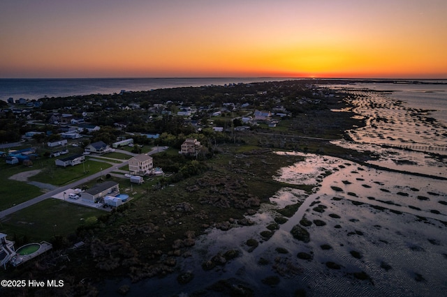 aerial view at dusk with a water view