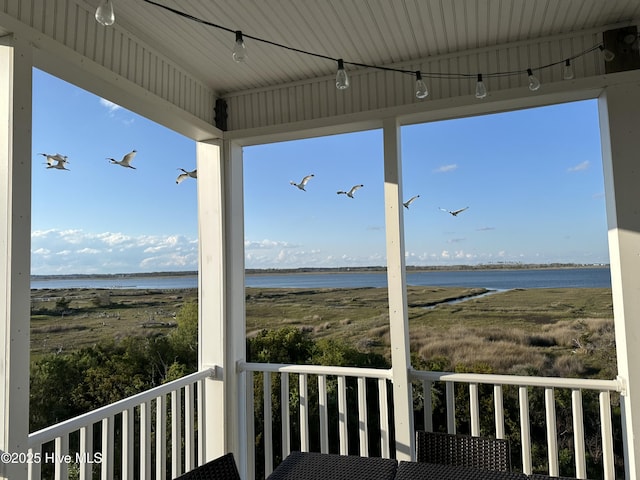 wooden terrace featuring a water view