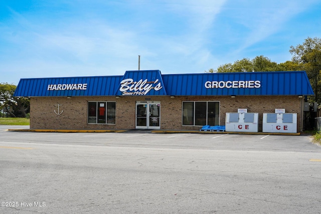 view of building exterior featuring uncovered parking
