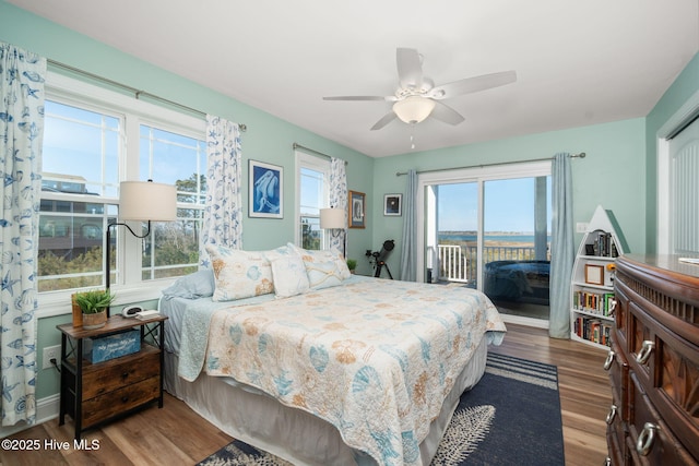 bedroom with ceiling fan, wood finished floors, and access to exterior