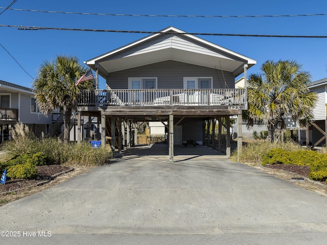 beach home featuring covered porch and a carport