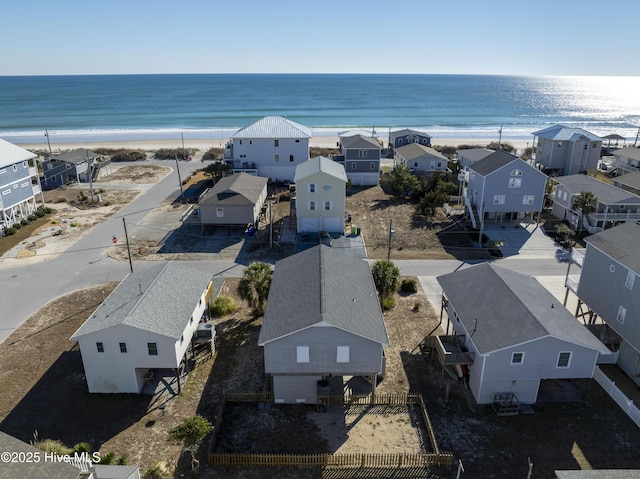 drone / aerial view featuring a view of the beach and a water view