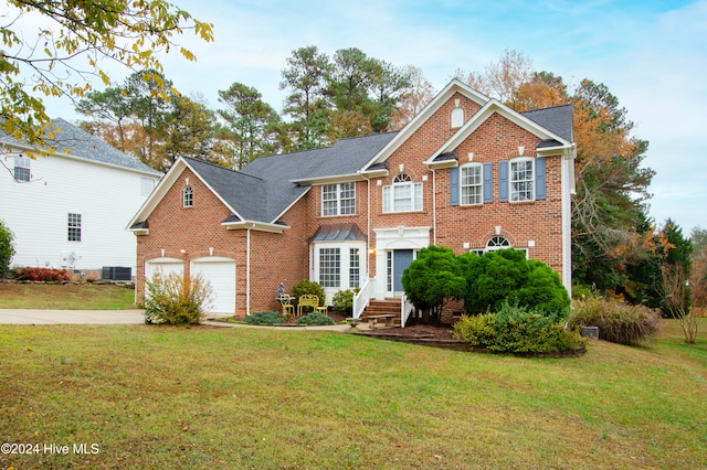 view of front of house with a front yard and a garage