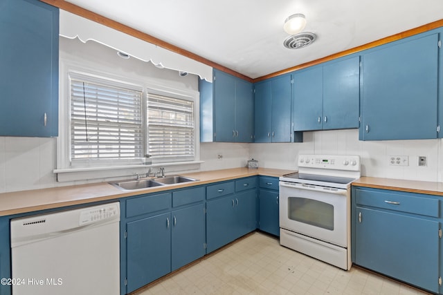 kitchen with white appliances, blue cabinets, and sink