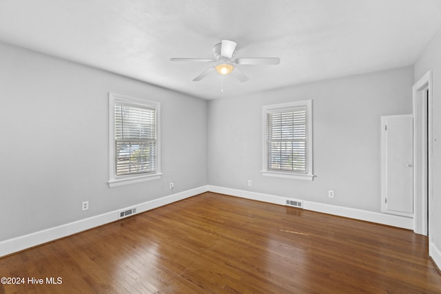 unfurnished room with dark hardwood / wood-style floors and ceiling fan