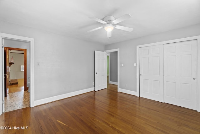 unfurnished bedroom featuring dark hardwood / wood-style flooring, a closet, and ceiling fan