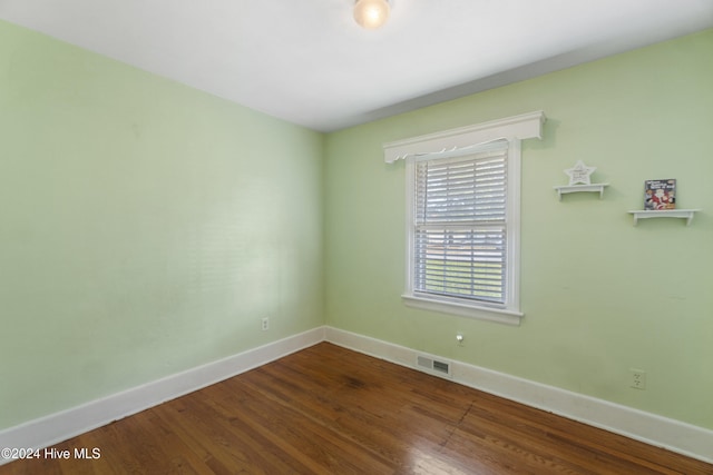 spare room featuring wood-type flooring