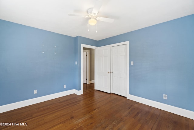 unfurnished bedroom featuring a closet, ceiling fan, and dark hardwood / wood-style flooring