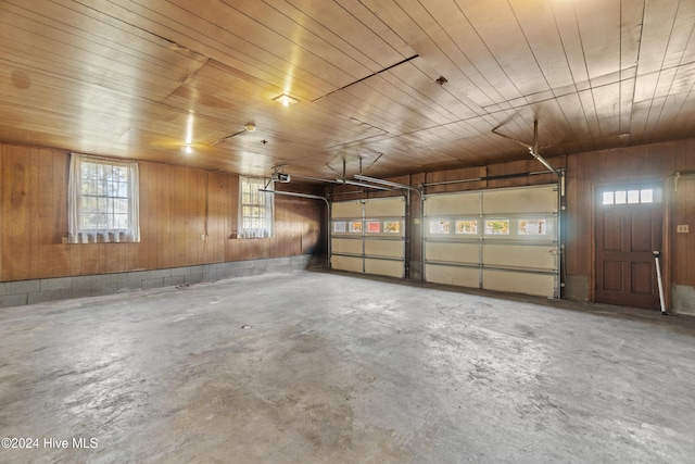 garage featuring wood walls and wood ceiling