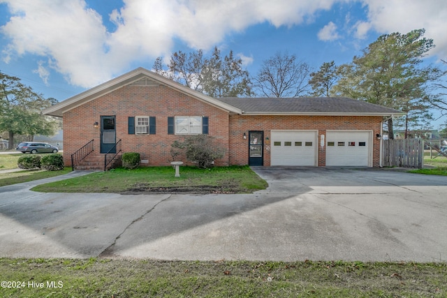 ranch-style home with a front yard and a garage