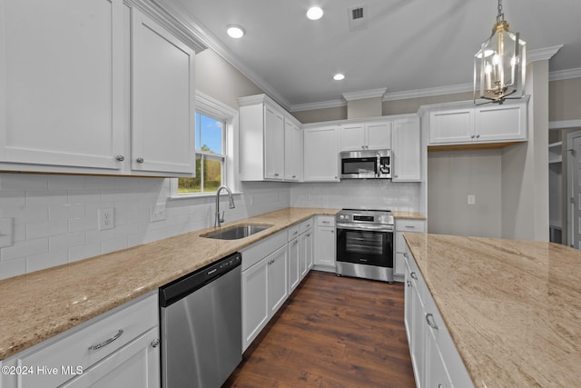 kitchen featuring sink, light stone countertops, decorative light fixtures, white cabinetry, and stainless steel appliances