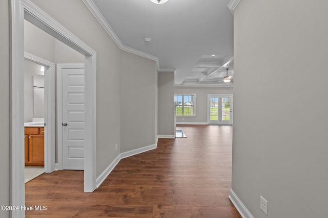 hallway with beam ceiling, dark wood-type flooring, crown molding, and coffered ceiling