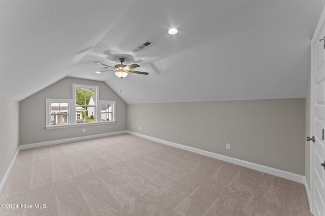 bonus room with light carpet, ceiling fan, and lofted ceiling