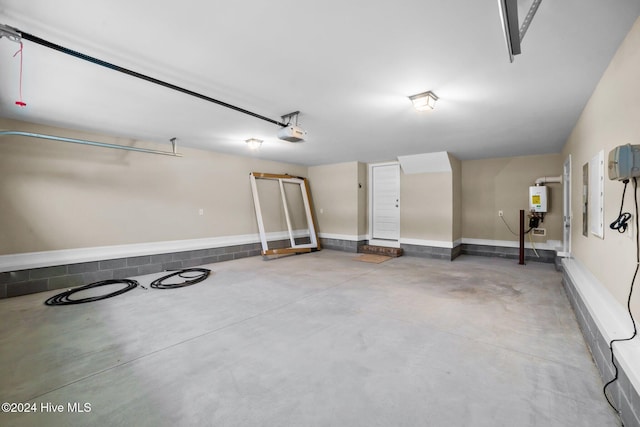 garage featuring tankless water heater and a garage door opener