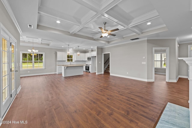 unfurnished living room with ornamental molding, coffered ceiling, ceiling fan with notable chandelier, dark wood-type flooring, and beam ceiling