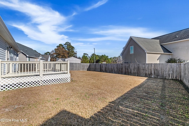 view of yard with a wooden deck