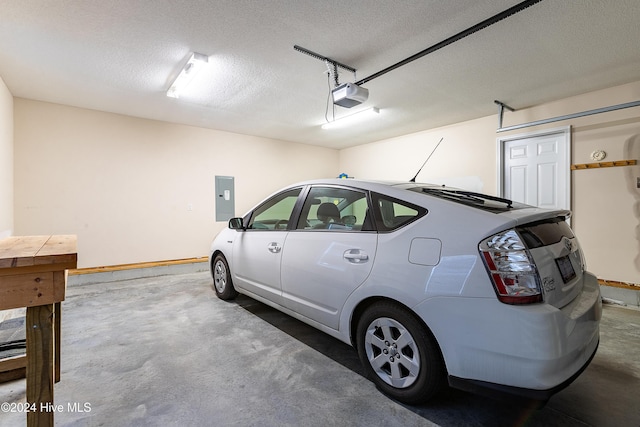 garage with electric panel and a garage door opener