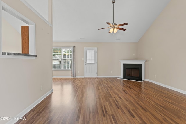 unfurnished living room with hardwood / wood-style floors, high vaulted ceiling, and ceiling fan