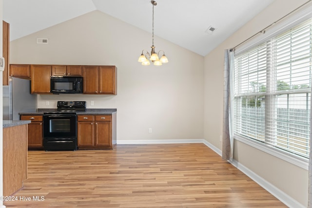 kitchen with a notable chandelier, lofted ceiling, black appliances, light wood-type flooring, and decorative light fixtures