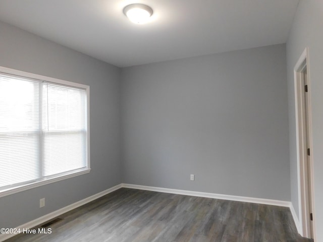 spare room featuring dark wood-type flooring