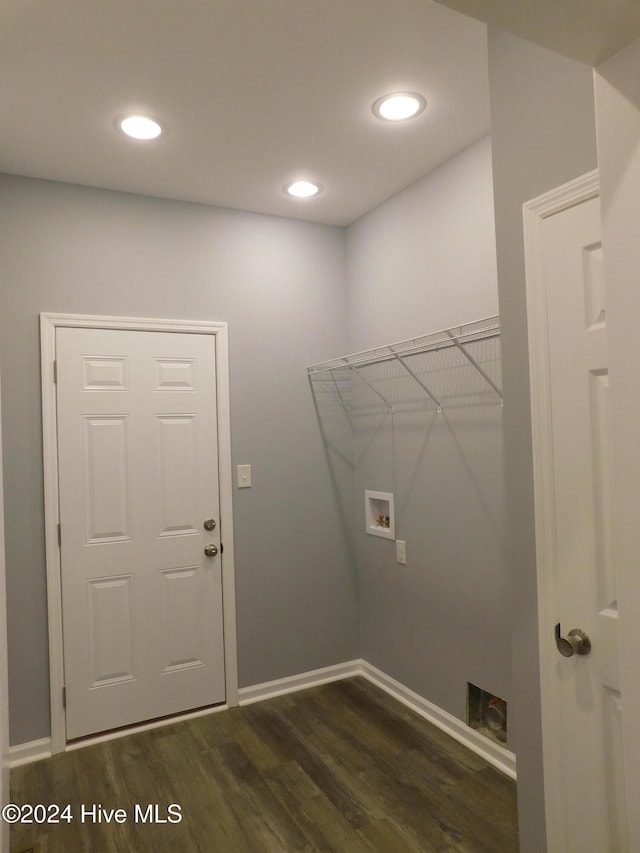 clothes washing area featuring dark hardwood / wood-style flooring and washer hookup