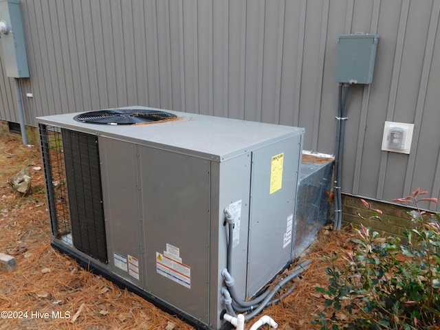 12521 Mckinnon Dr, Laurinburg, NC 28352 - exterior view of a cooling unit and board and batten siding