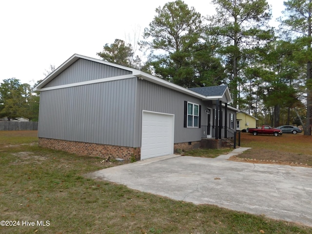 view of side of home with a lawn and a garage