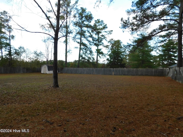 12521 Mckinnon Dr, Laurinburg, NC 28352 - fenced backyard with a storage unit