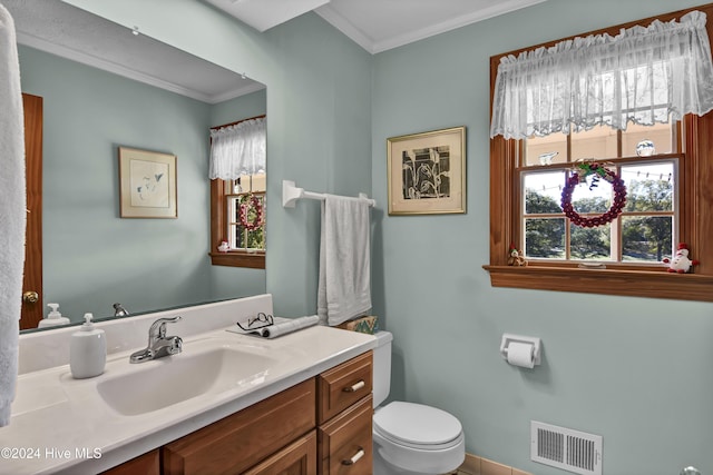 bathroom with crown molding, tile patterned flooring, vanity, and toilet