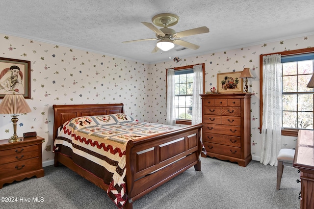 carpeted bedroom with a textured ceiling, ceiling fan, and ornamental molding