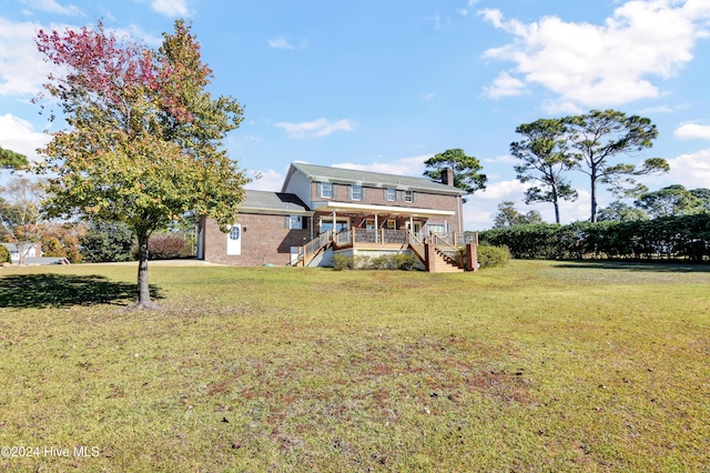 rear view of property with a lawn