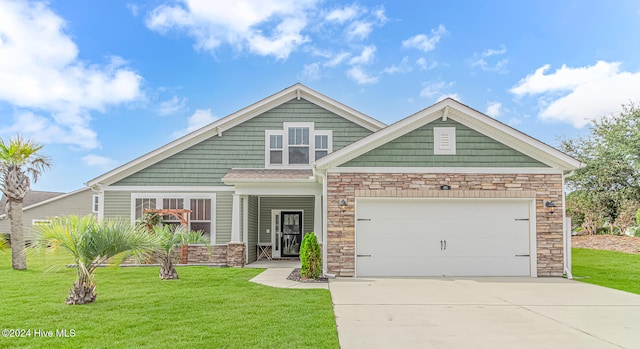 craftsman-style home featuring a garage and a front lawn