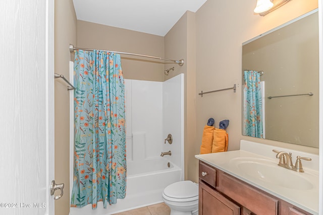 full bathroom featuring tile patterned flooring, shower / bath combo, toilet, and vanity