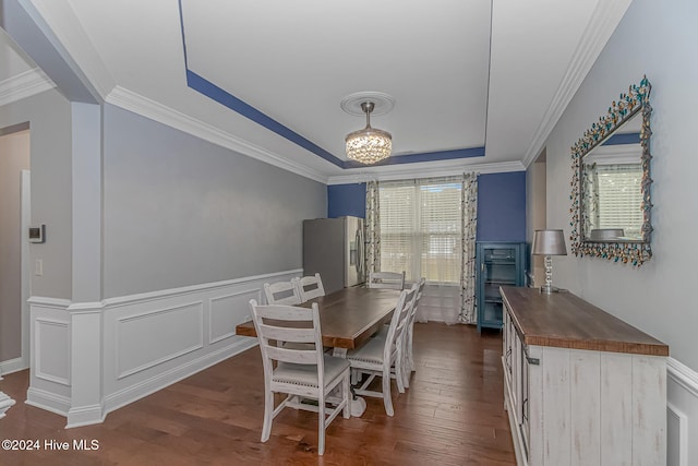 dining area featuring dark hardwood / wood-style floors, a raised ceiling, plenty of natural light, and crown molding