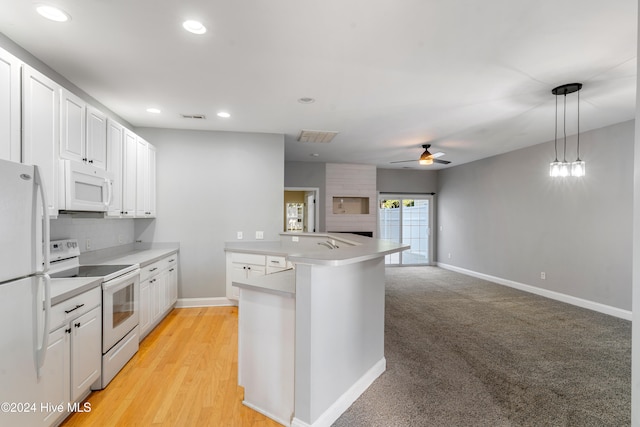 kitchen featuring white appliances, ceiling fan, light hardwood / wood-style flooring, white cabinetry, and hanging light fixtures