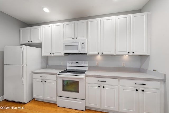 kitchen featuring white cabinets, white appliances, and light wood-type flooring