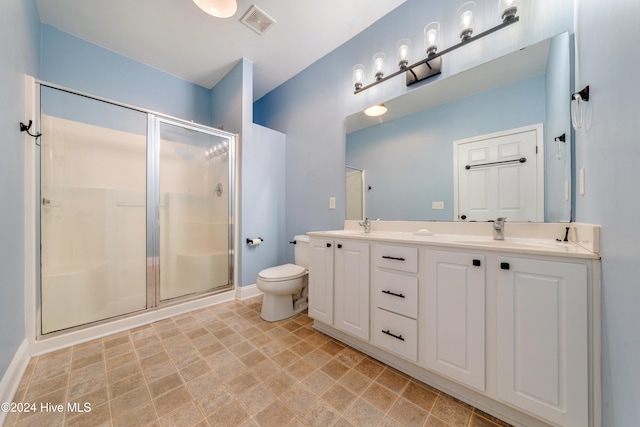 bathroom with vanity, toilet, and walk in shower