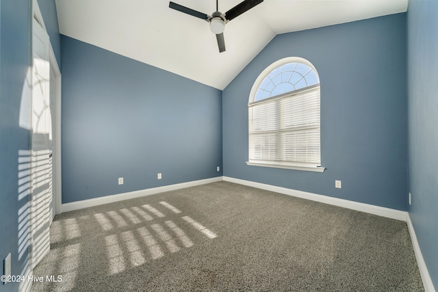 carpeted empty room featuring ceiling fan and vaulted ceiling