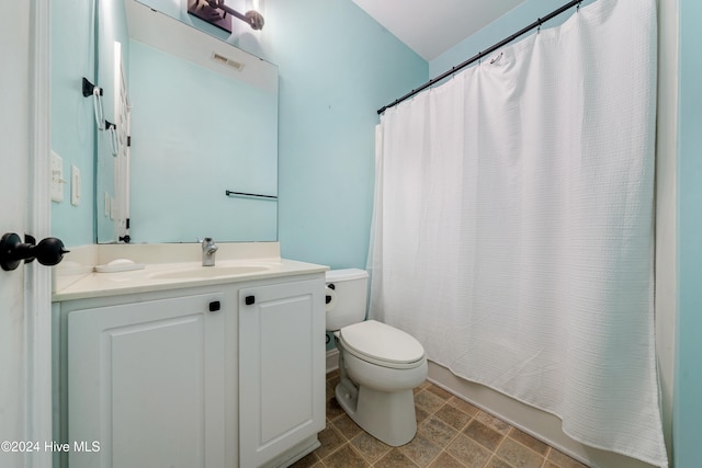 full bathroom with vanity, toilet, and shower / bath combo with shower curtain