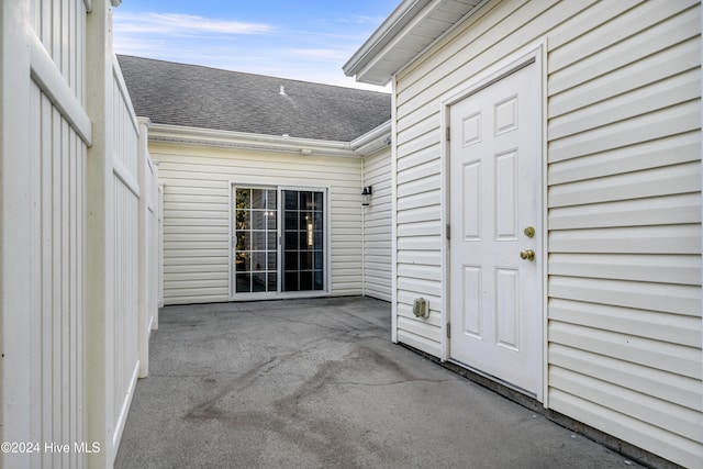 view of exterior entry featuring a patio