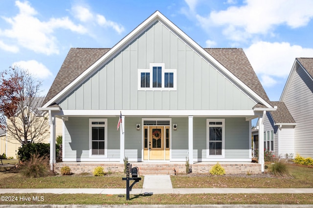 4067 Reunion Pointe Ln, New Bern, NC 28562 - view of front of home with a shingled roof, board and batten siding, and a porch